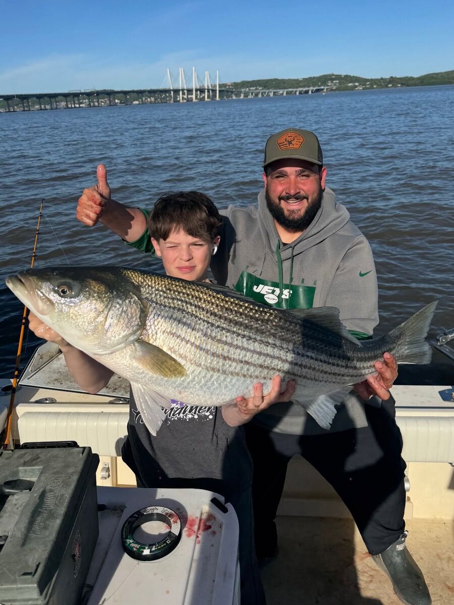 A young angler with his striped bass
