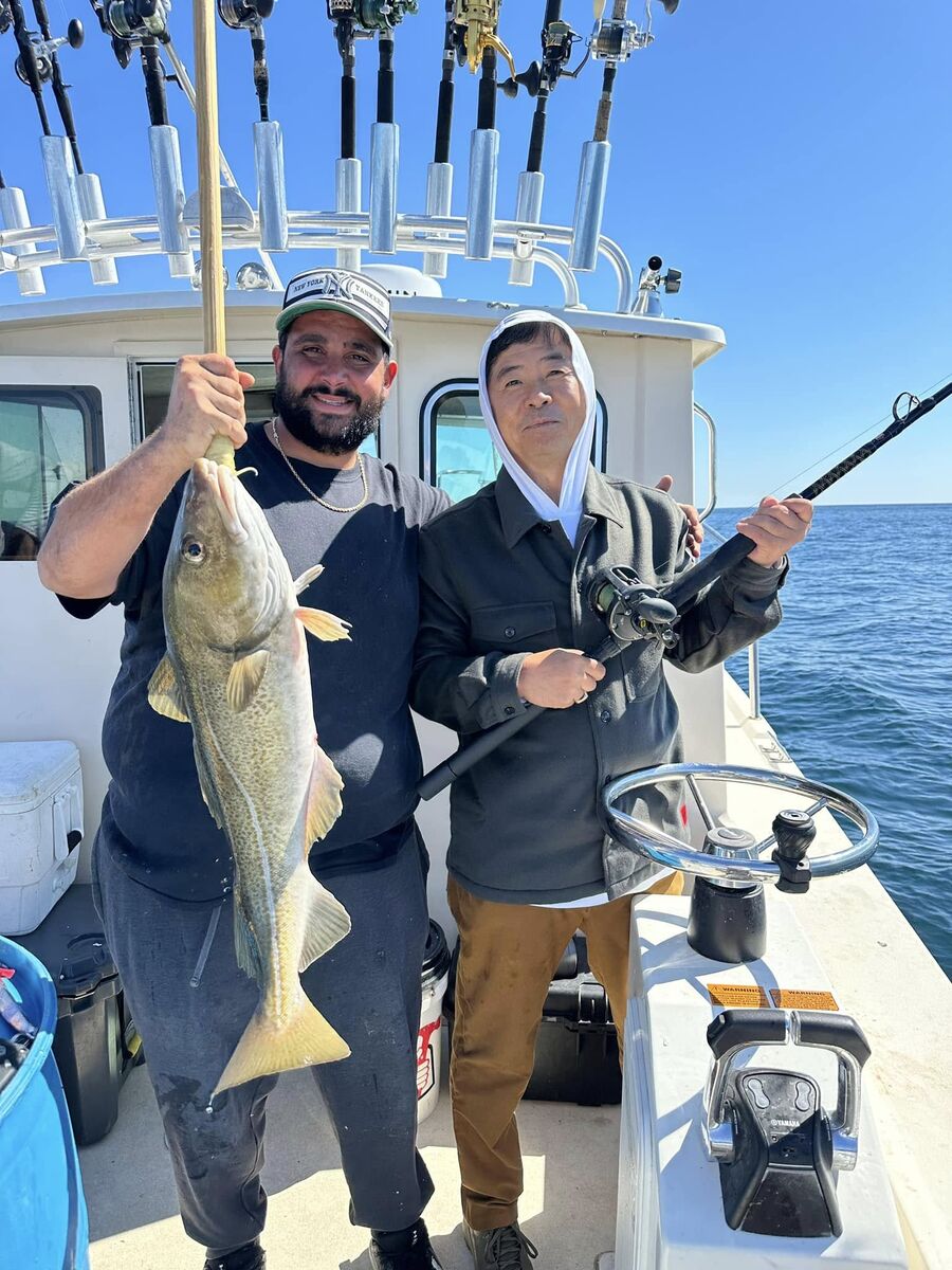 Anglers with a striped bass on board