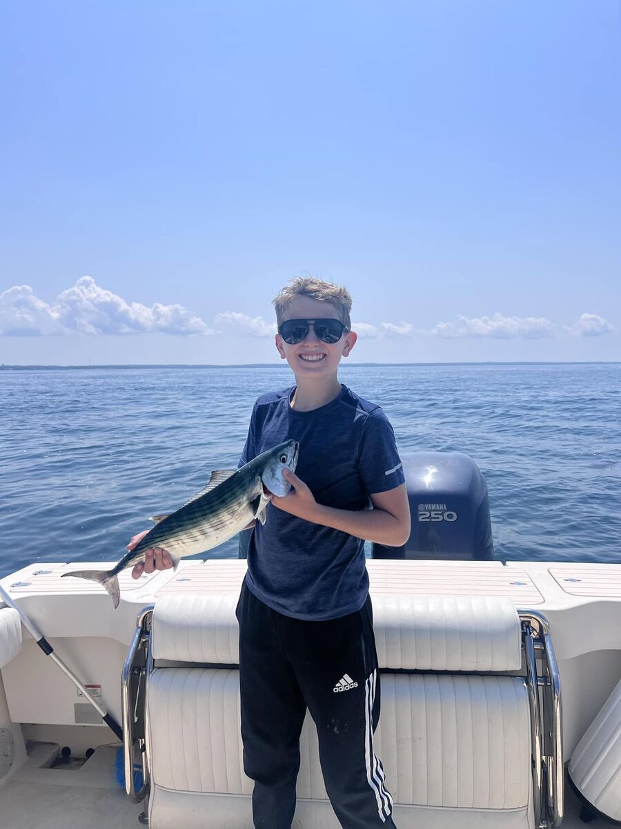 A young angler with his first fish of the day